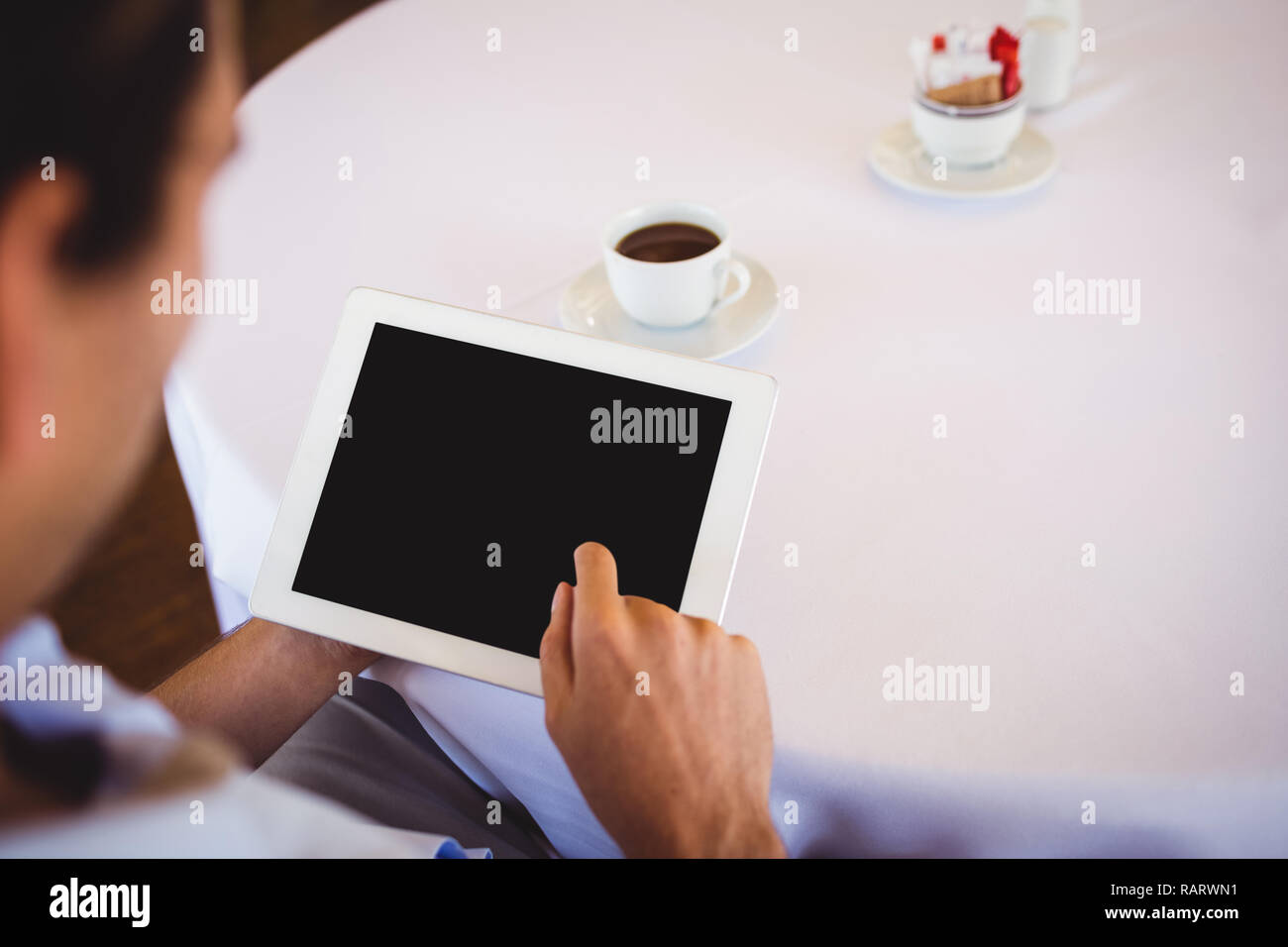 Man using digital tablet in restaurant Stock Photo