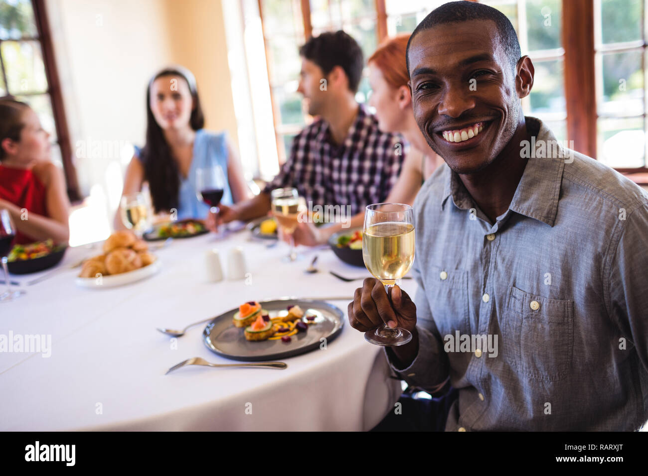 Man holding wine glass in restaurant Stock Photo Alamy