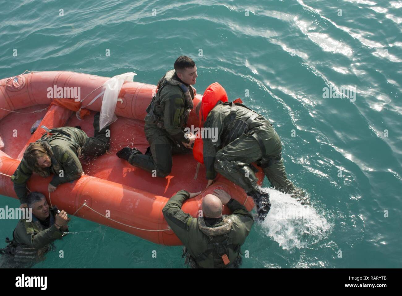 Kuwait- Soldiers climb aboard a survival raft to await rescue from the ...
