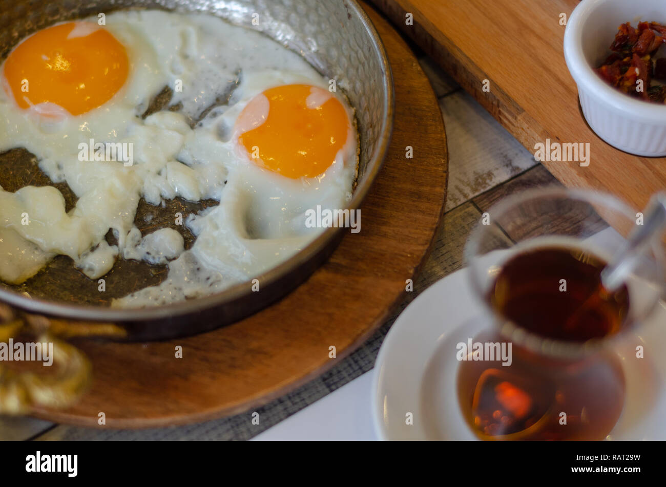 Fried eggs and turkish tea on the table,top view. Stock Photo