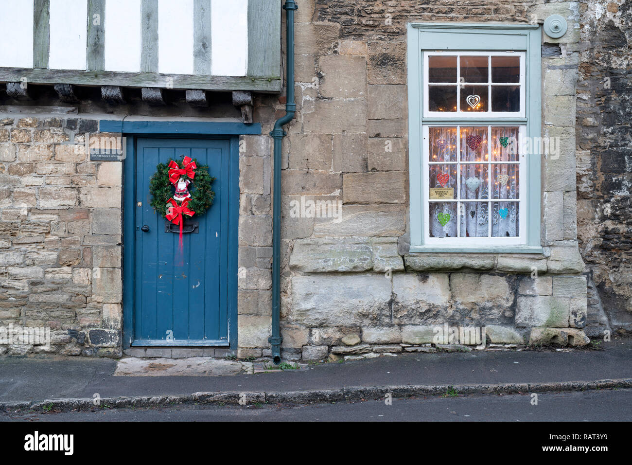 Christmas wreath on a cottage door in Lacock. Cotswolds, Wiltshire