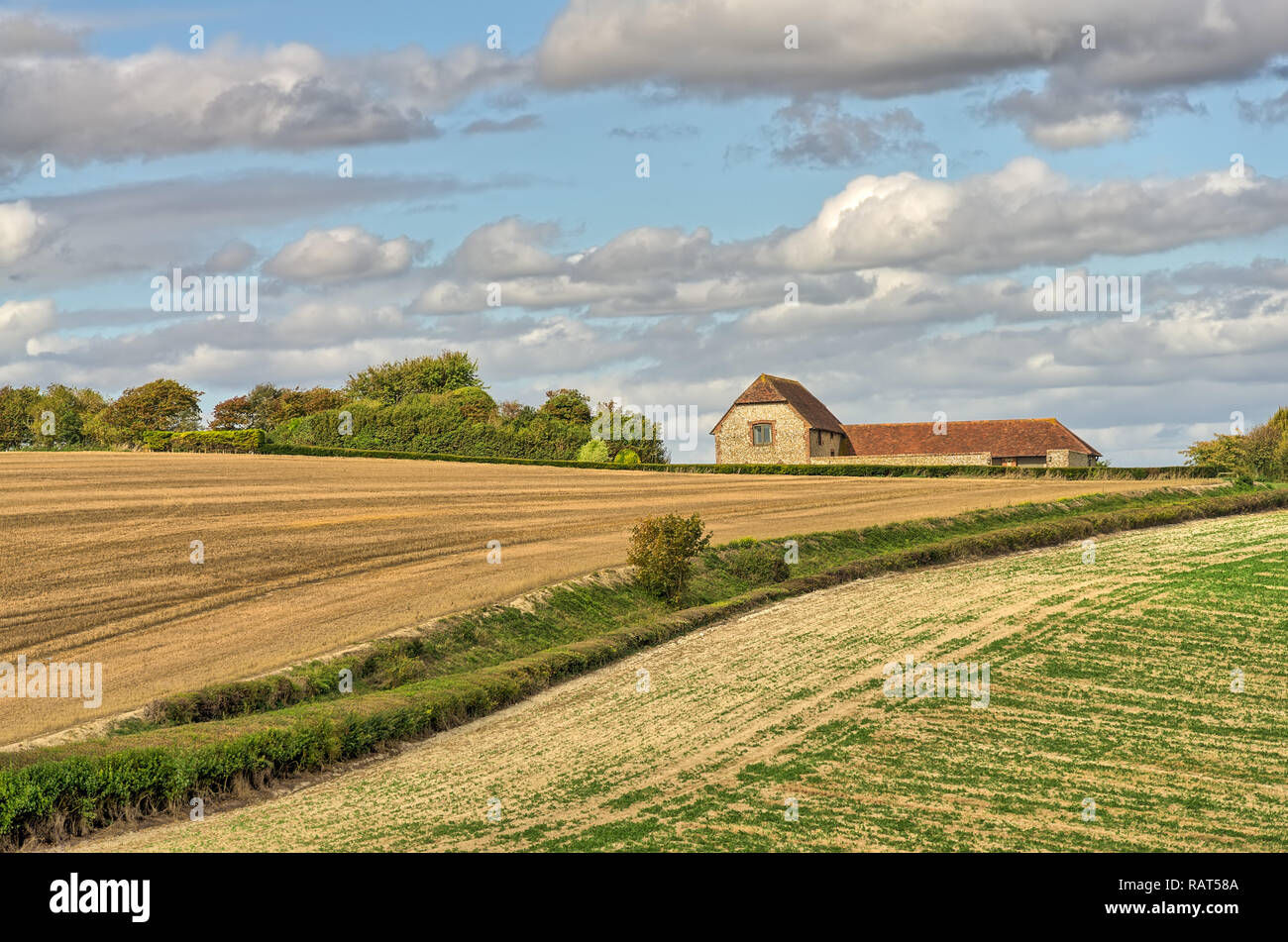 A view of a converted barn and farmland in late summer. Stock Photo