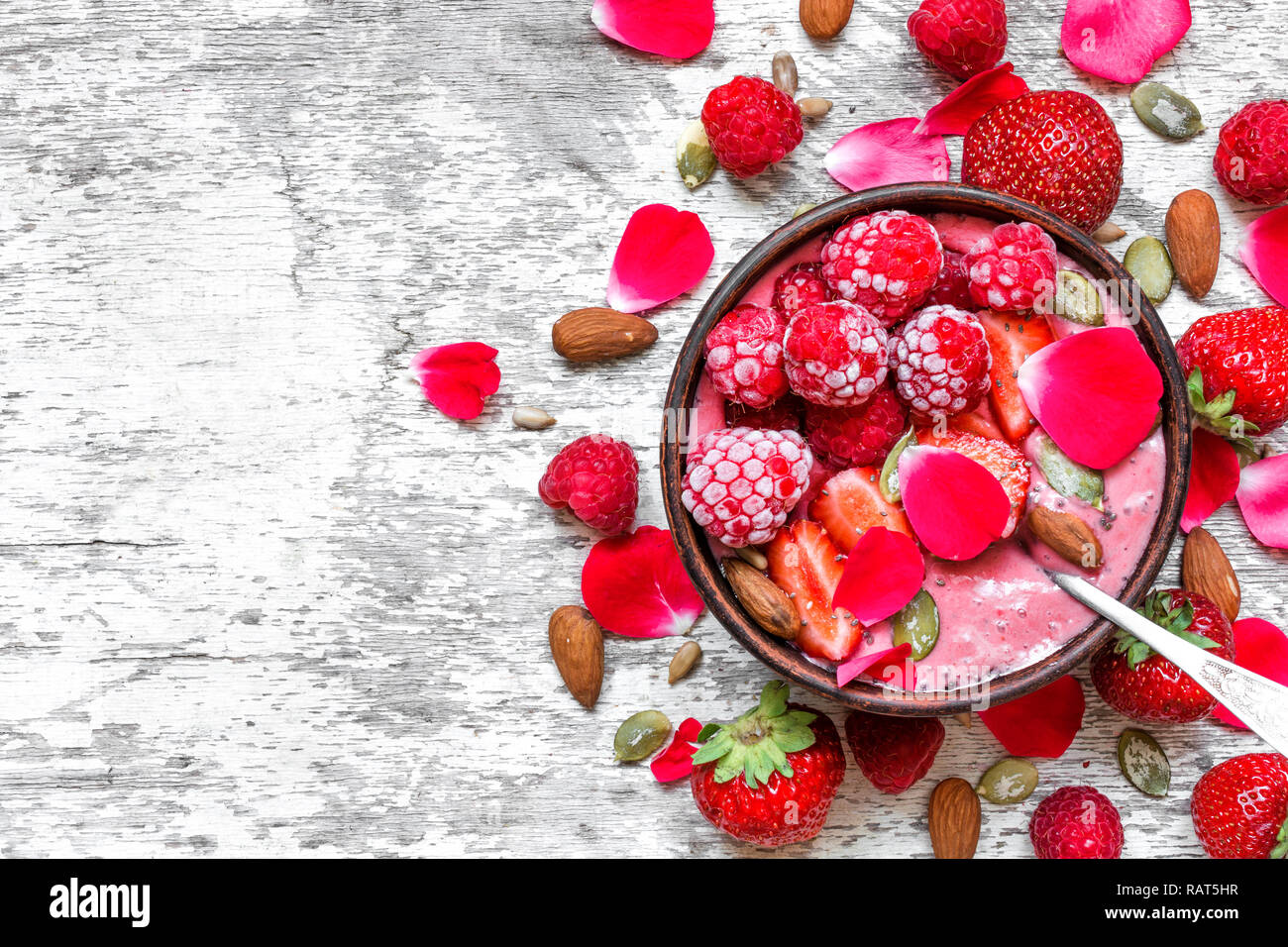 healthy breakfast. bowl of red berry smoothie with strawberry