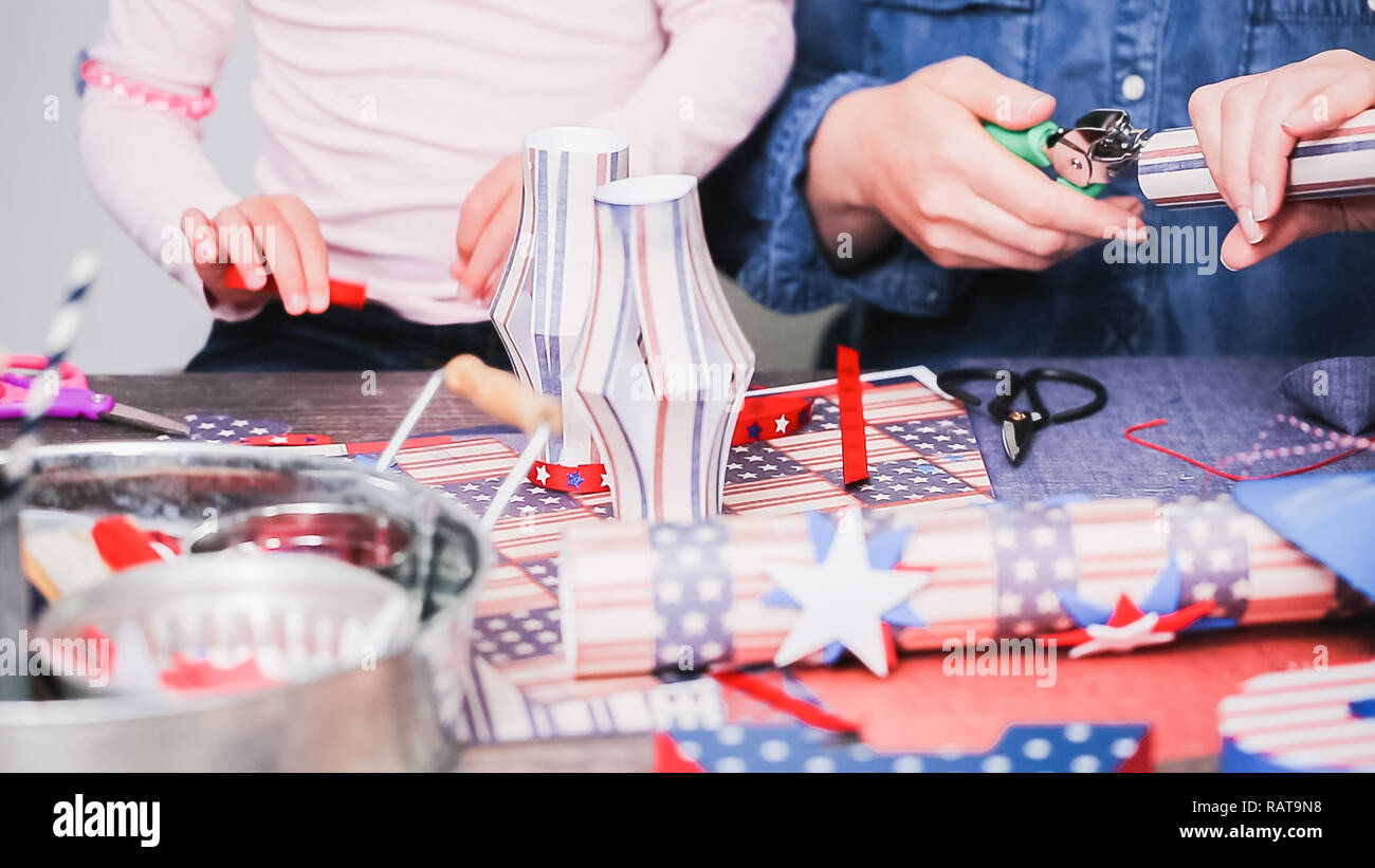 Step by step. Mother and daughter making paper firecrackers for July ...