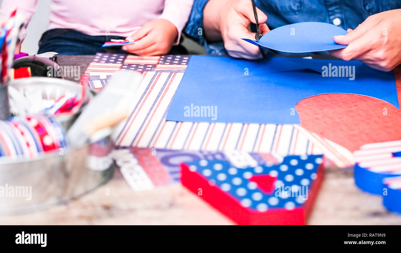 Step by step. Mother and daughter making paper firecrackers for July ...