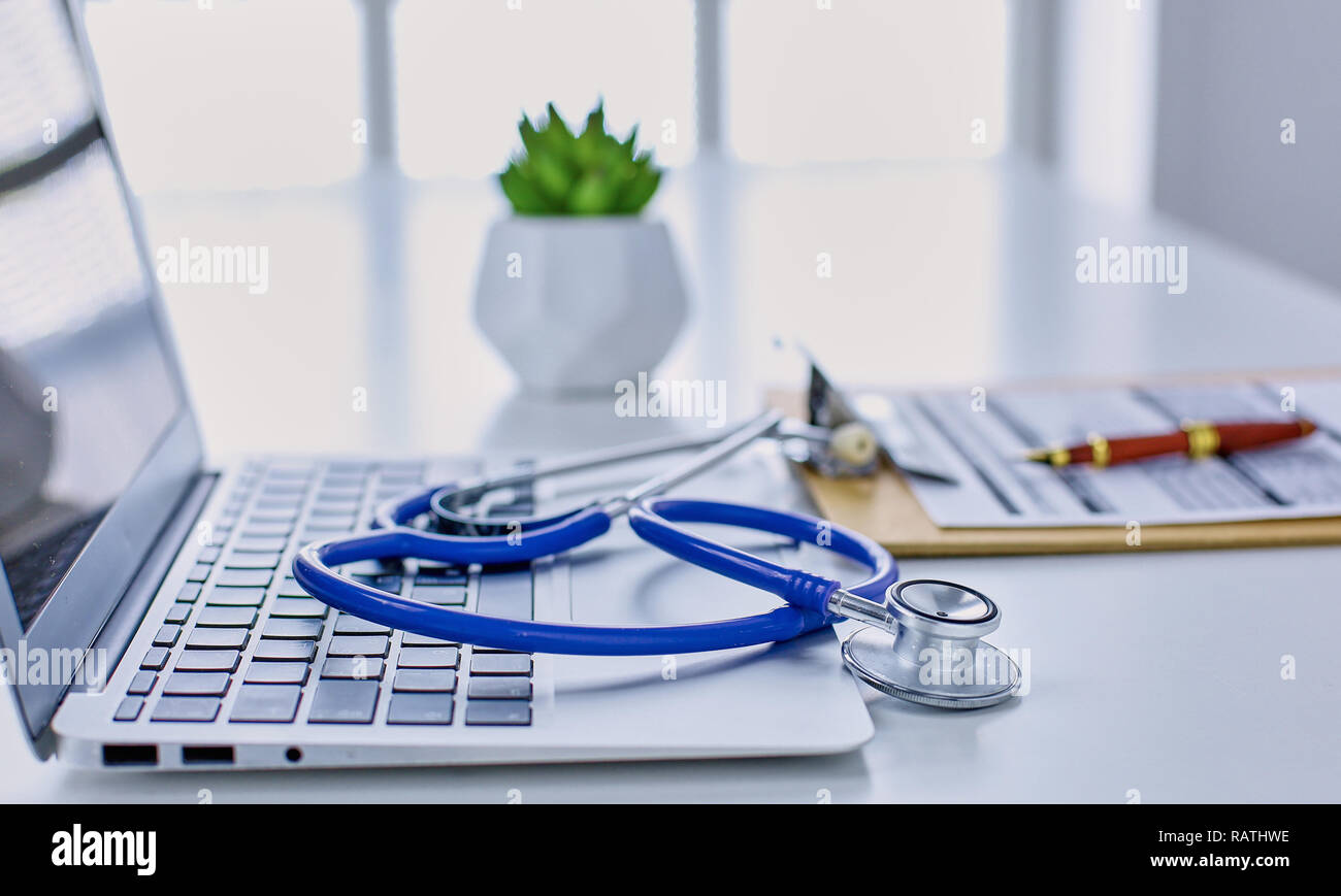 Doctor's workspace working table with patient's discharge blank paper ...