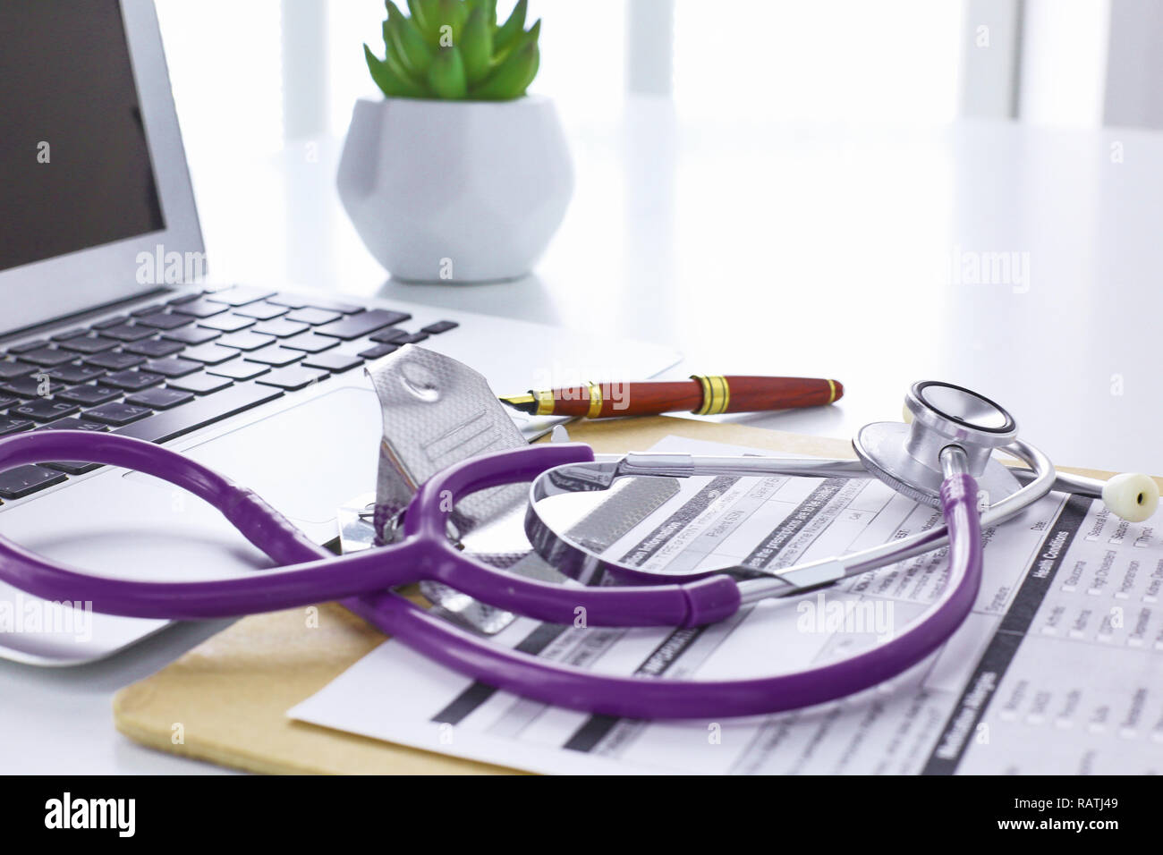 Doctor's workspace working table with patient's discharge blank paper ...