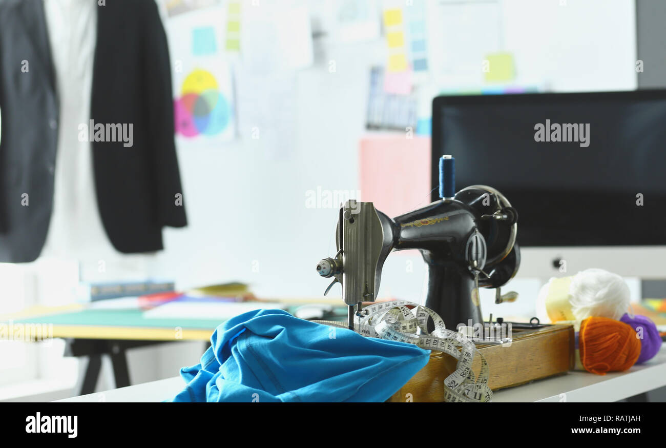 Retro sewing machine on designer clothes desktop Stock Photo - Alamy