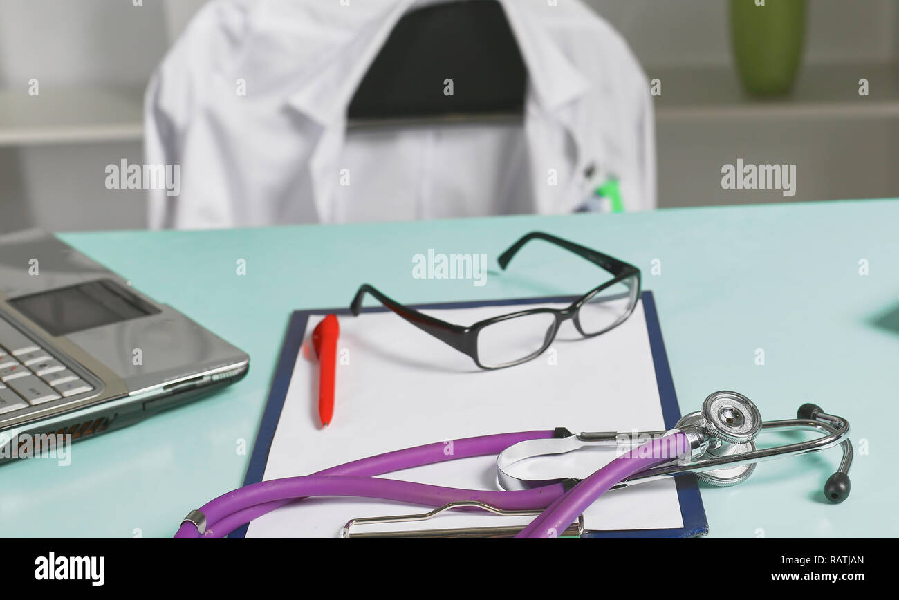 Doctor's workspace working table with patient's discharge blank paper ...