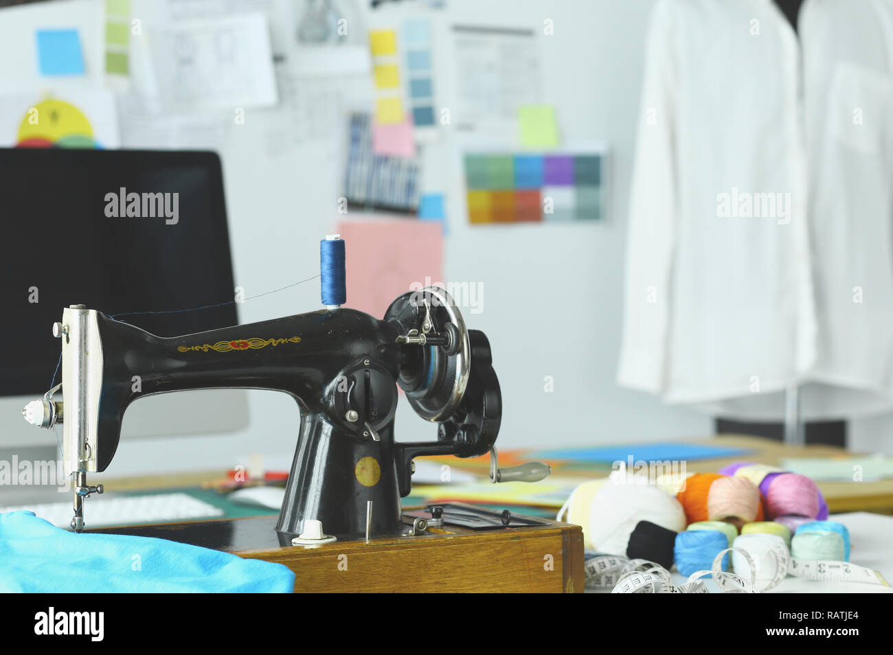 Retro sewing machine on designer clothes desktop Stock Photo - Alamy
