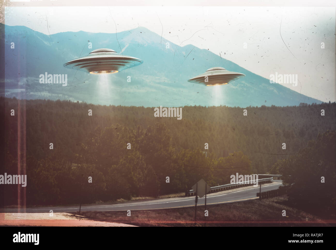Unidentified flying object. Two UFOs flying over a road among the trees. 3D illustration retro photo vintage. Noise and defects of old photo film. Stock Photo