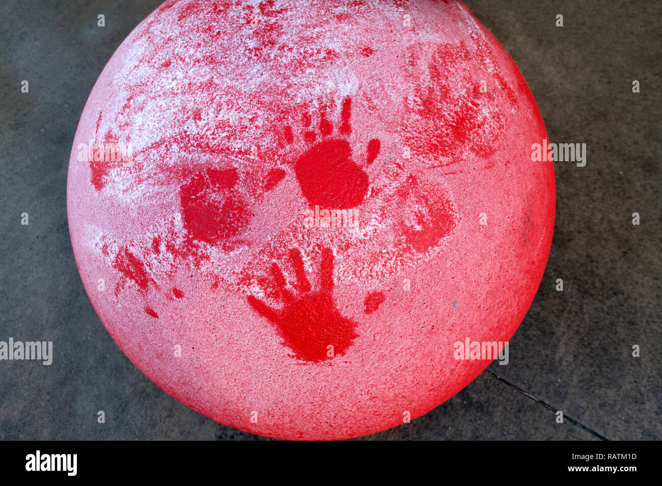 Artistic surface of a red traffic standard with hand prints in the snow. St Paul Minnesota MN USA Stock Photo