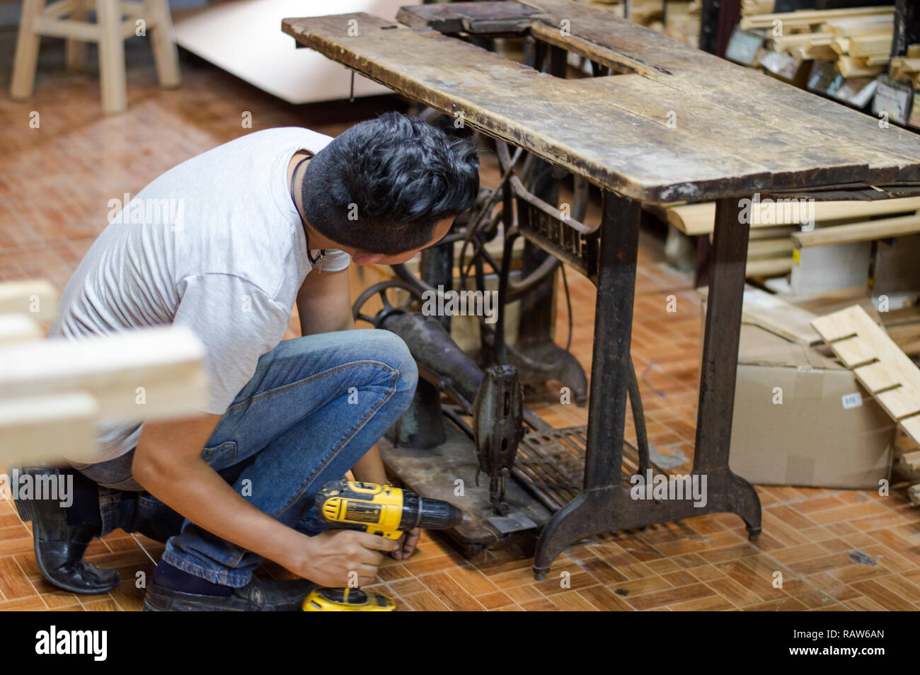Carpenter restoring old sawing machine Stock Photo