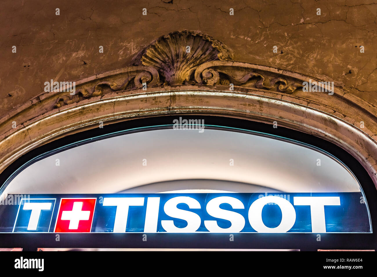 ROME, ITALY - JANUARY 3, 2019: lights are enlightening TISSOT logo on storefront at night Stock Photo