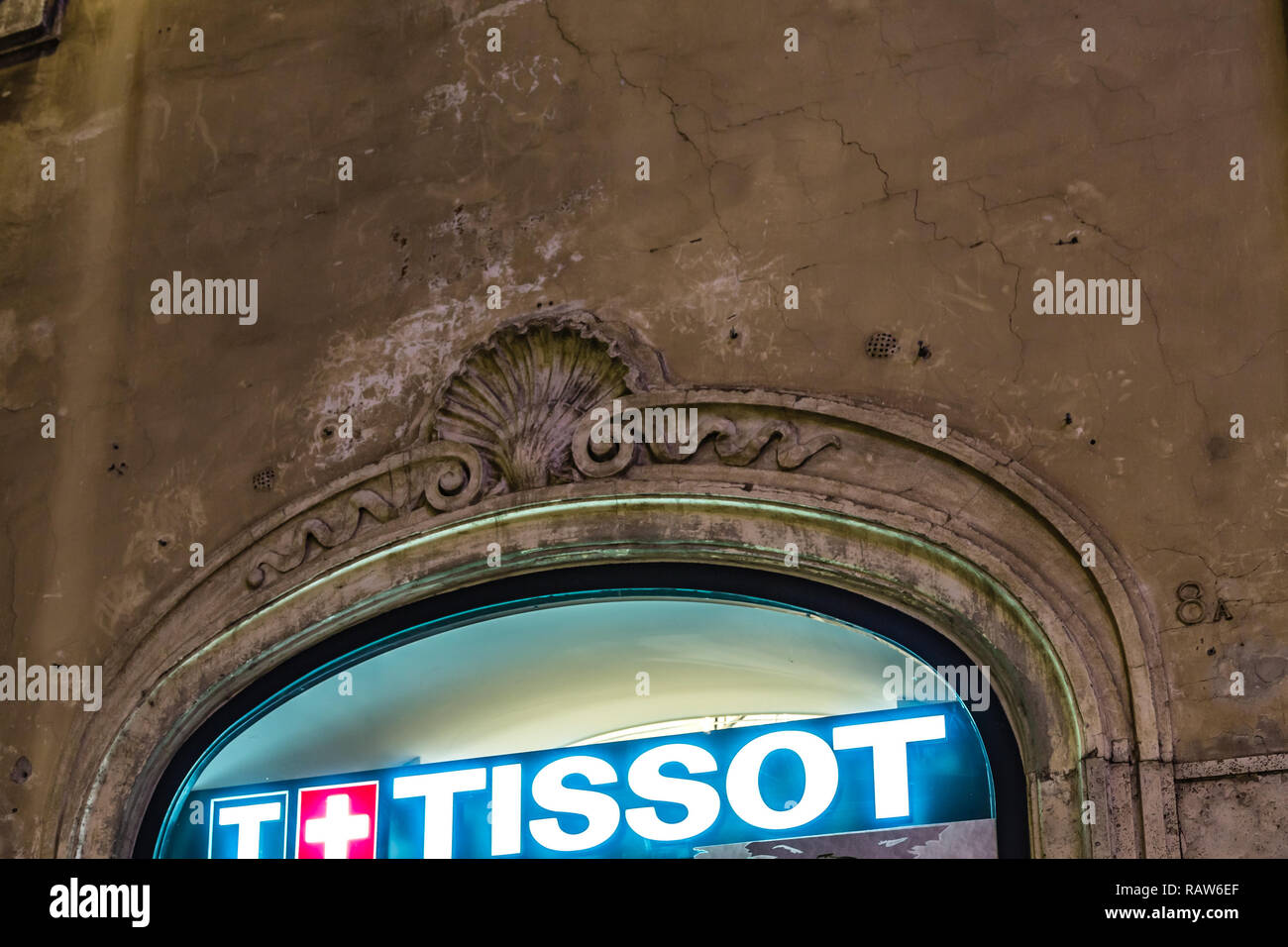 ROME, ITALY - JANUARY 3, 2019: lights are enlightening TISSOT logo on storefront at night Stock Photo