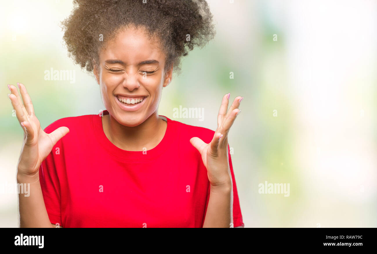 Young afro american woman over isolated background celebrating mad and ...