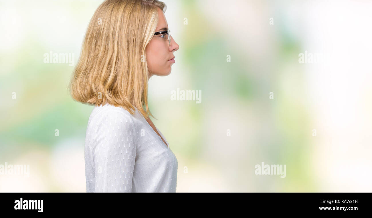 Beautiful young woman wearing glasses over isolated background looking ...