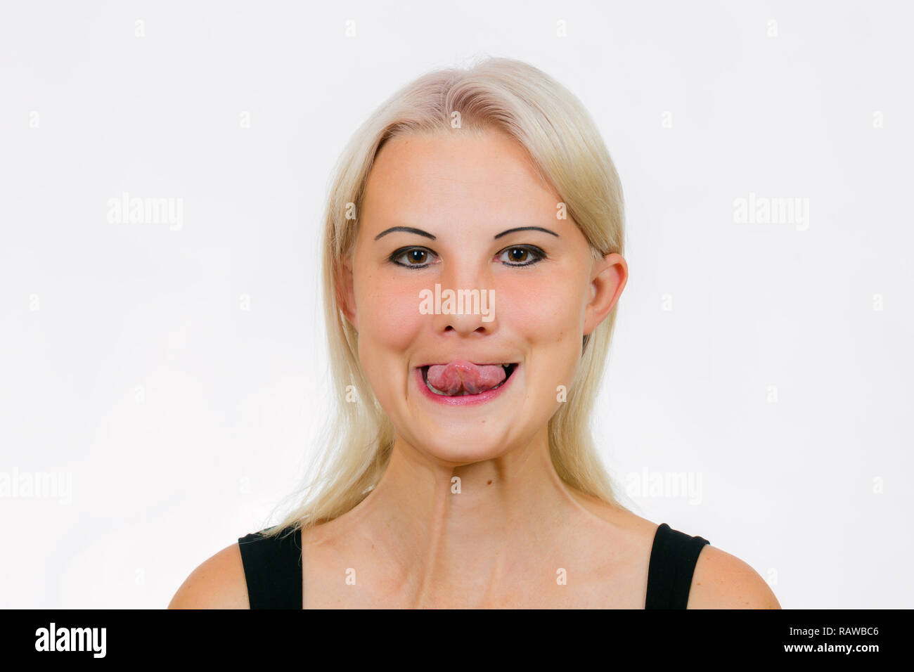 Face exercise touch your nose, woman tries to touch her nose with