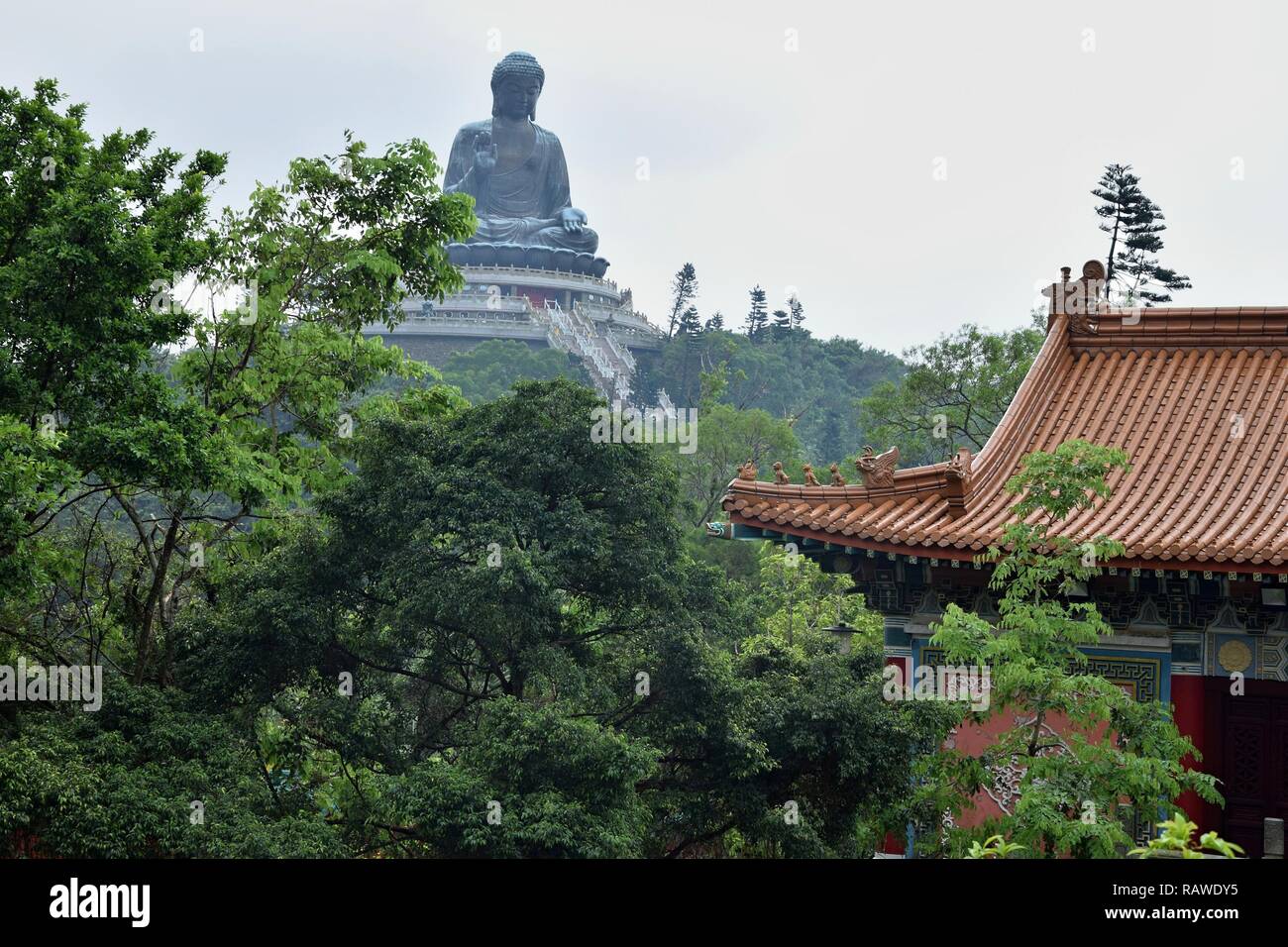 The landscape of Lantau Island in Hong Kong with the Tian Tan Buddha also known as Big Buddha in the background. Stock Photo
