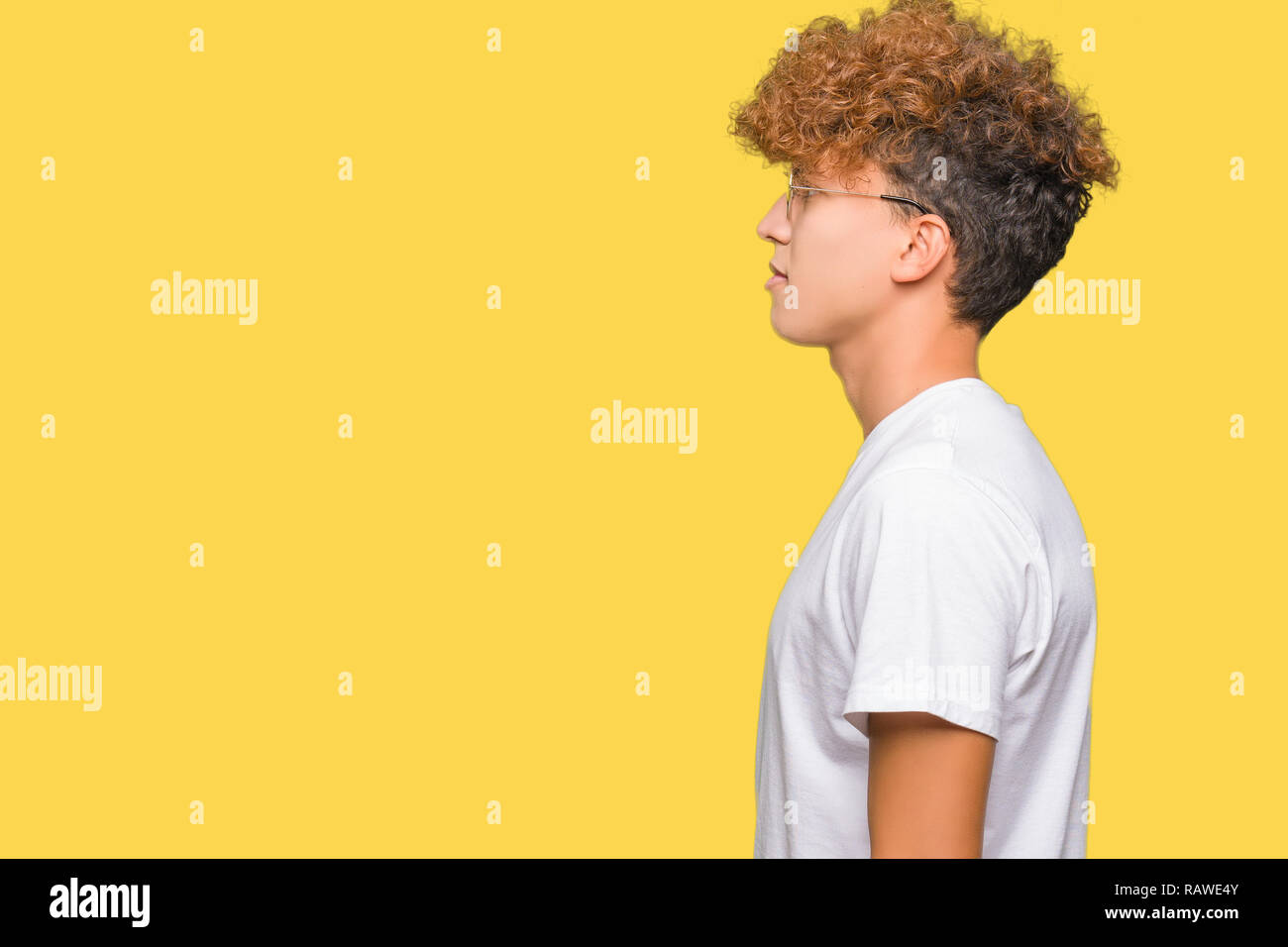 Young Handsome Man With Afro Hair Wearing Glasses Looking To Side