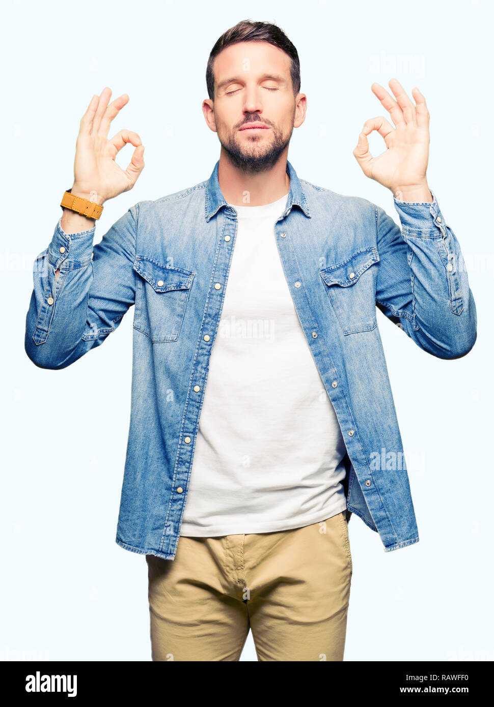 Handsome man with blue eyes and beard wearing denim jacket relax and  smiling with eyes closed doing meditation gesture with fingers. Yoga  concept Stock Photo - Alamy