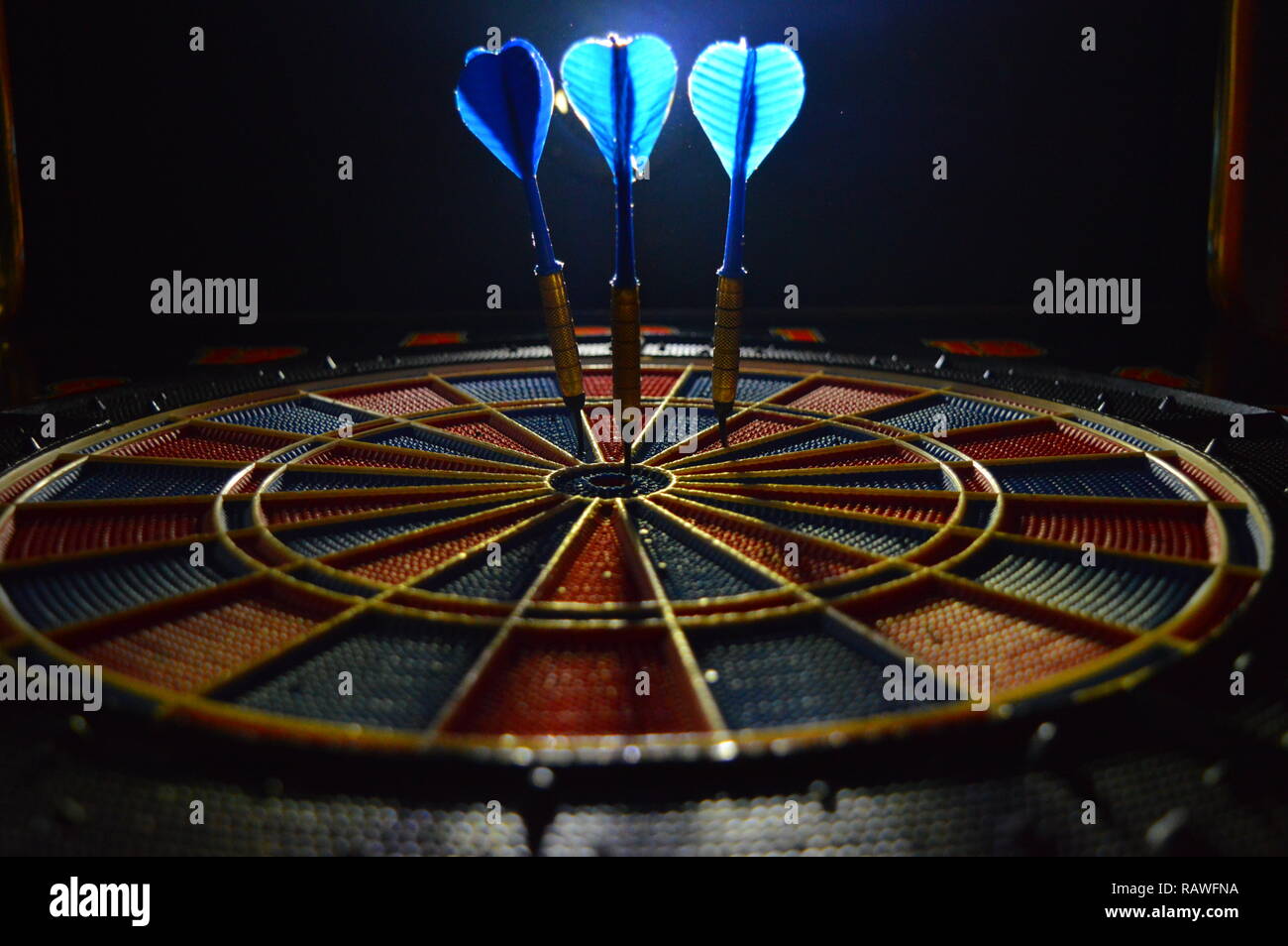 Game of darts, person playing darts hitting bulls eye Stock Photo