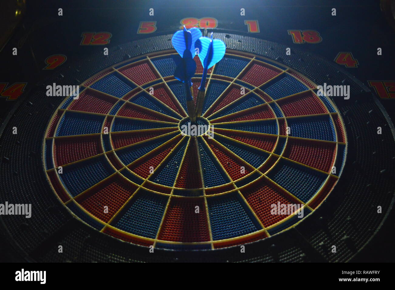 Game of darts, person playing darts hitting bulls eye Stock Photo