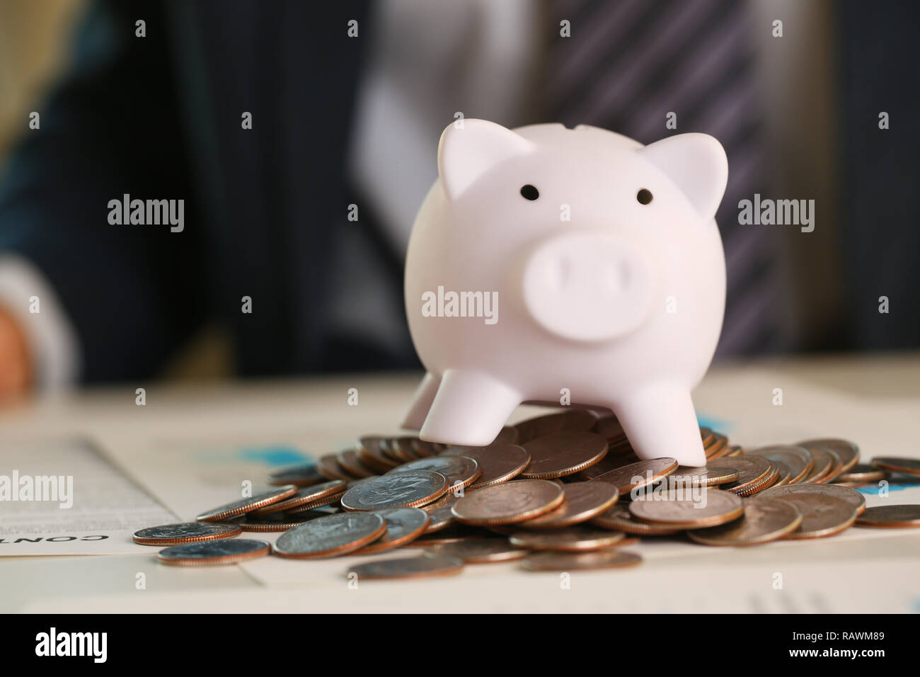 Hand businessman putting pin money into pig Stock Photo Alamy