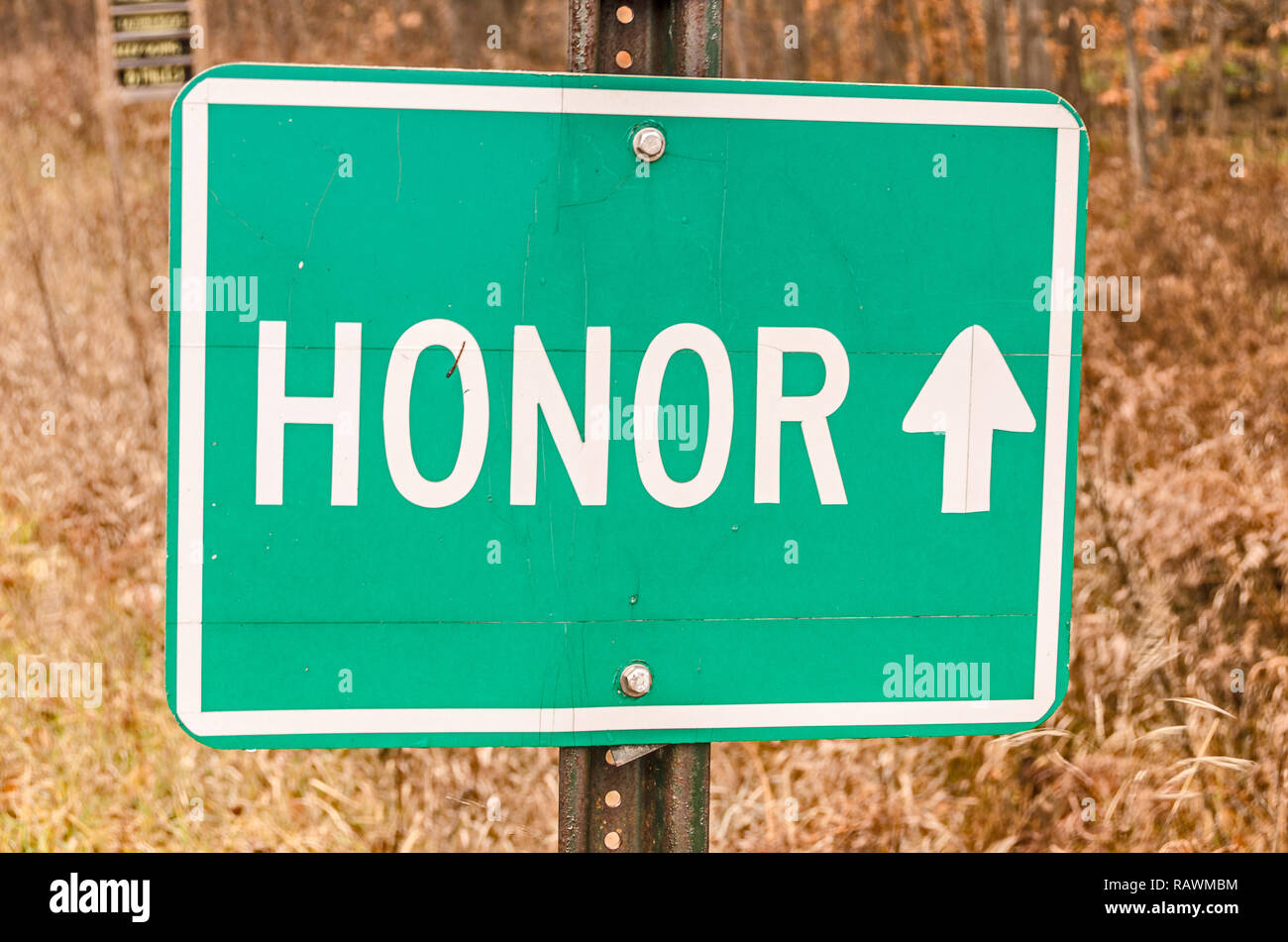 Green and white sign for the village of Honor Stock Photo Alamy