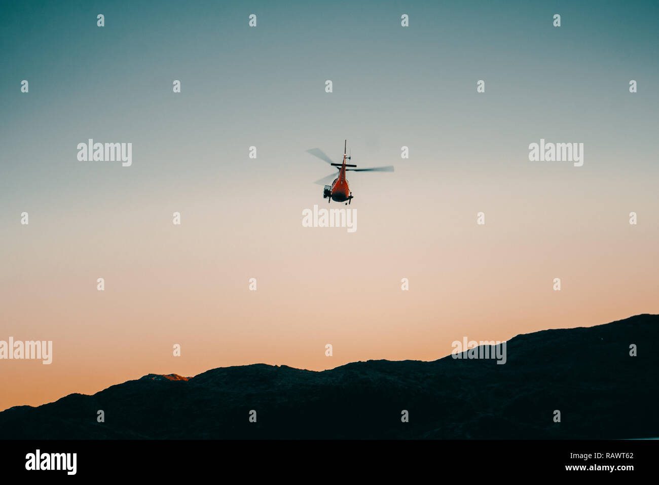 Helicopter flying away Stock Photo