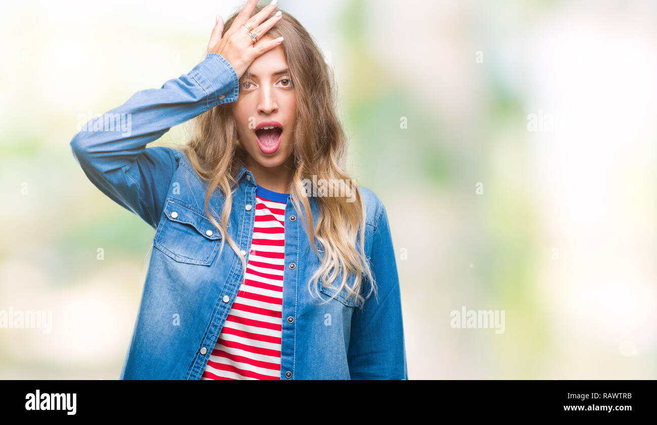 Beautiful young blonde woman over isolated background surprised with ...