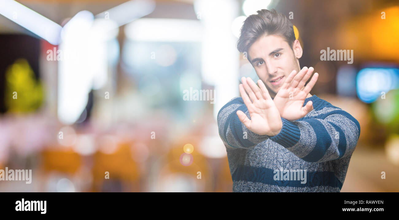 Young handsome man over isolated background Rejection expression ...