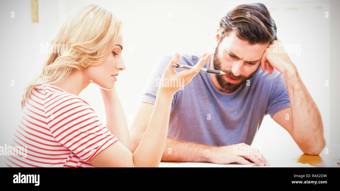 Worried young couple checking on bills Stock Photo
