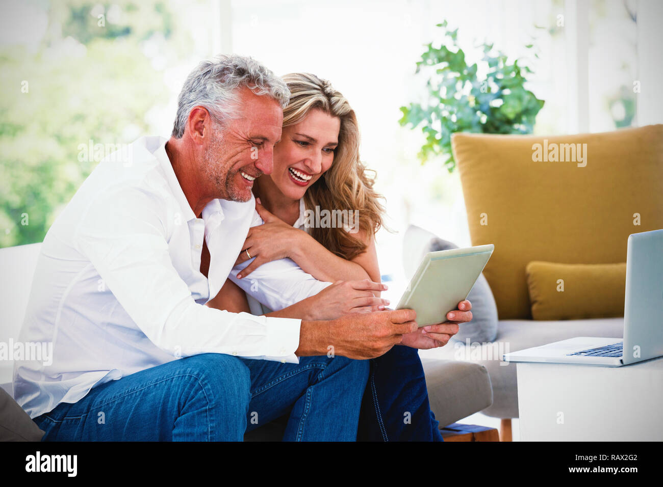 Smart mature couple using digital tablet Stock Photo