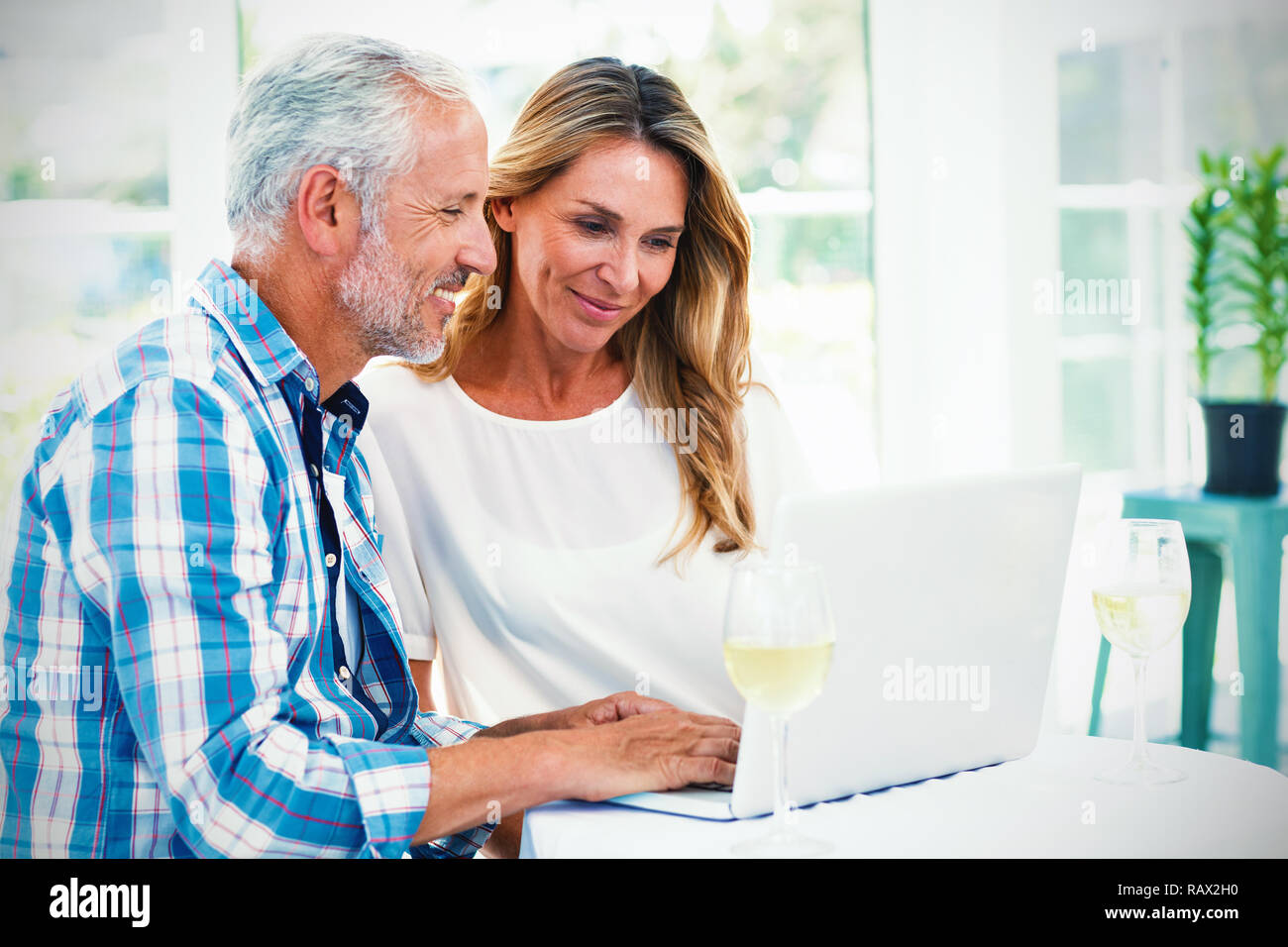 Couple looking in laptop on table Stock Photo