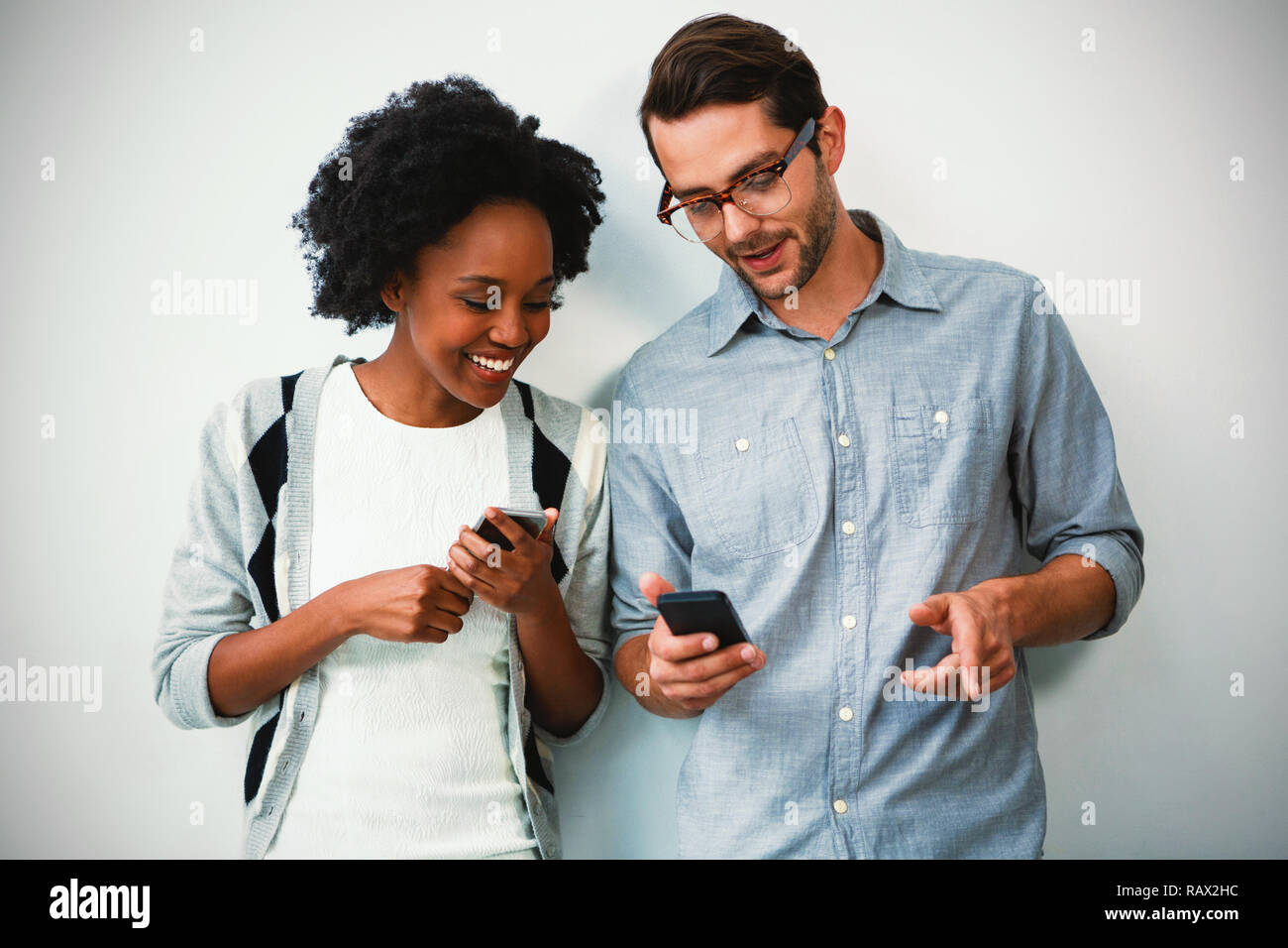 Man and woman using mobile phone Stock Photo