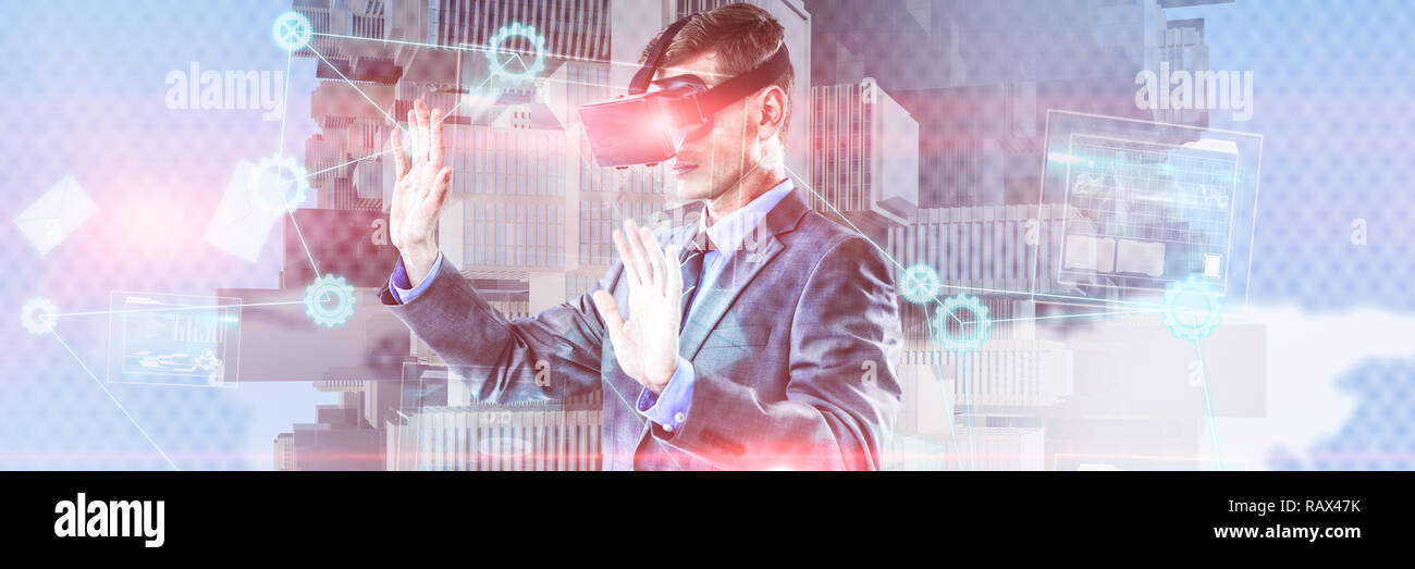 Composite image of businessman using virtual reality headset Stock Photo
