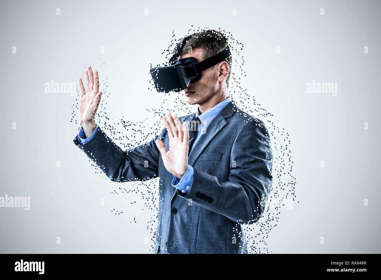 Composite image of businessman using virtual reality headset Stock Photo