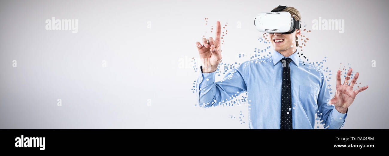 Composite image of happy young businessman gesturing while wearing futuristic glasses Stock Photo