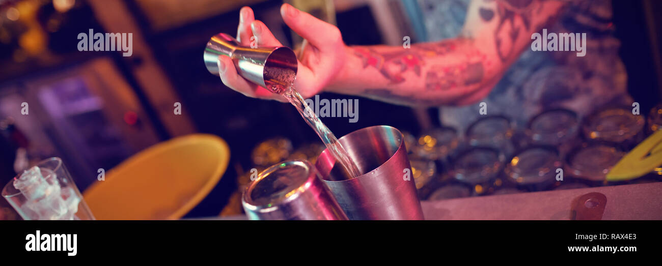 Bartender preparing a drink at counter Stock Photo