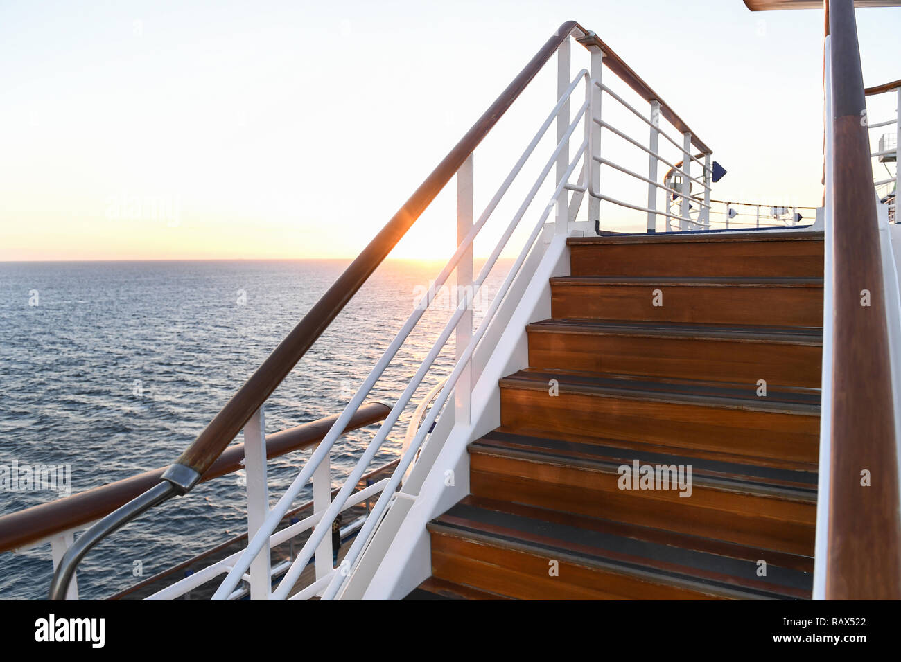 Railing and stairs of a cruise ship at sunset Stock Photo - Alamy