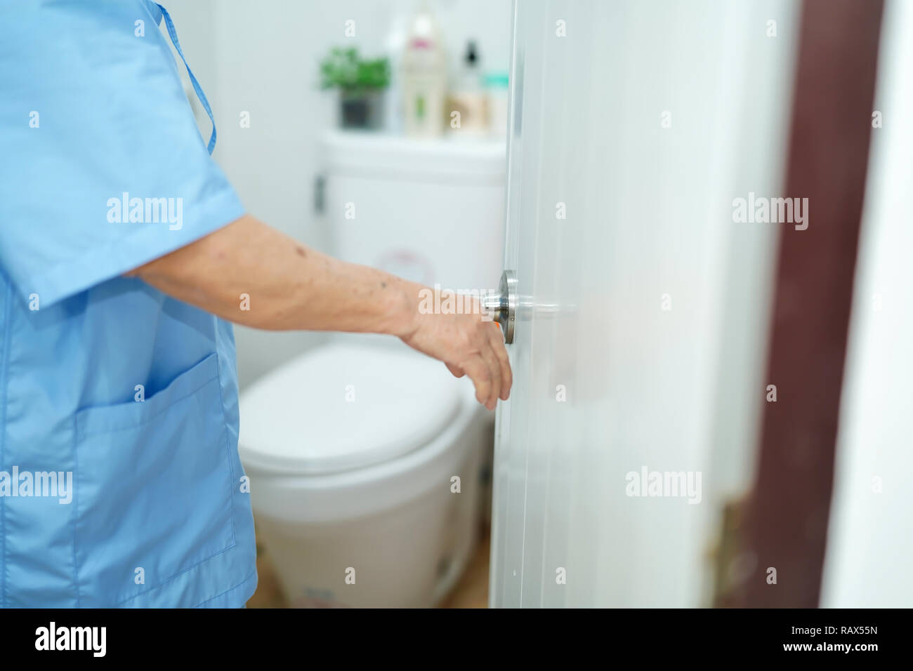 Asian senior elderly old lady woman patient open toilet bathroom by