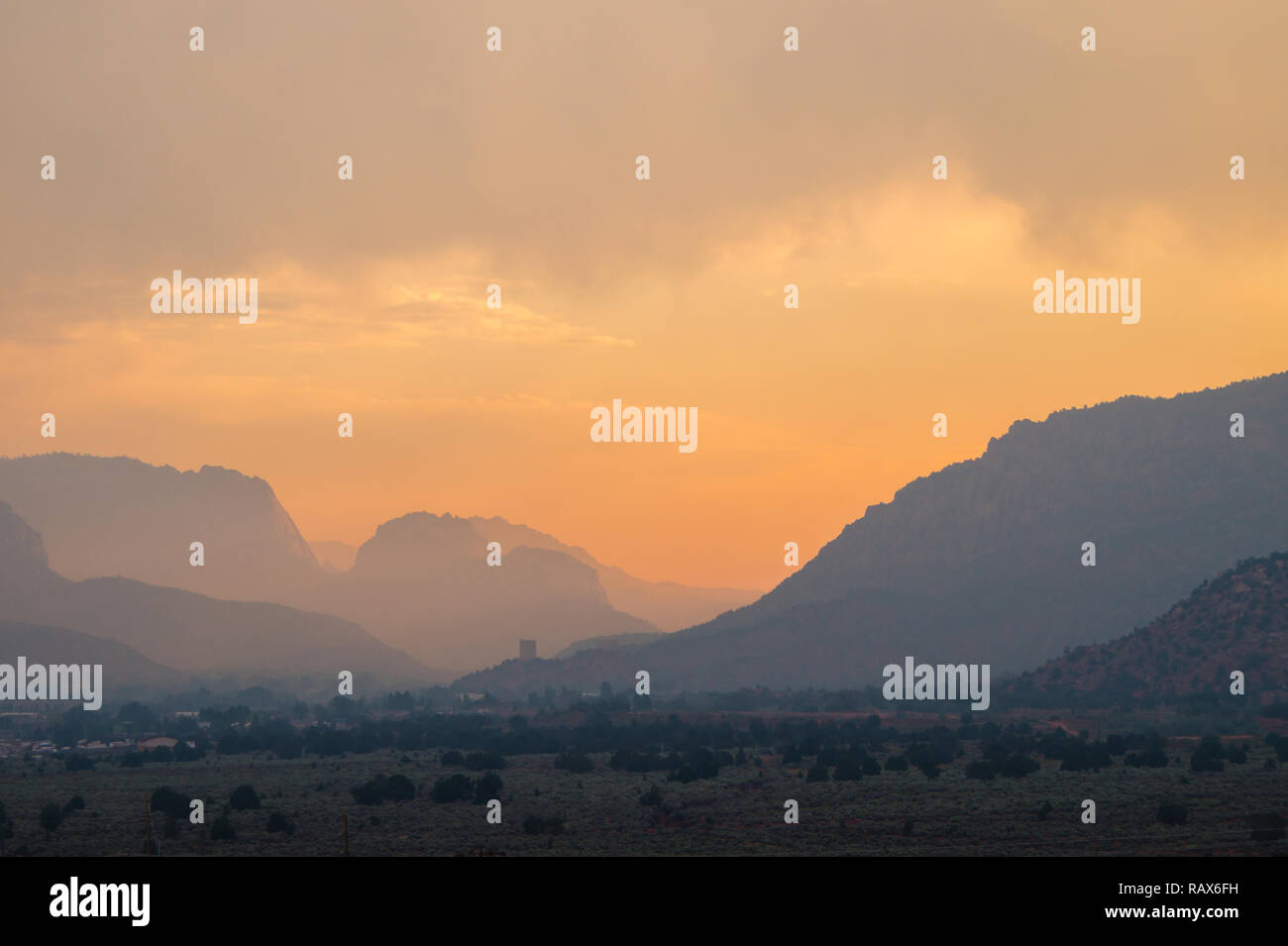 Hazey sunrise in the desert mountain layers Stock Photo