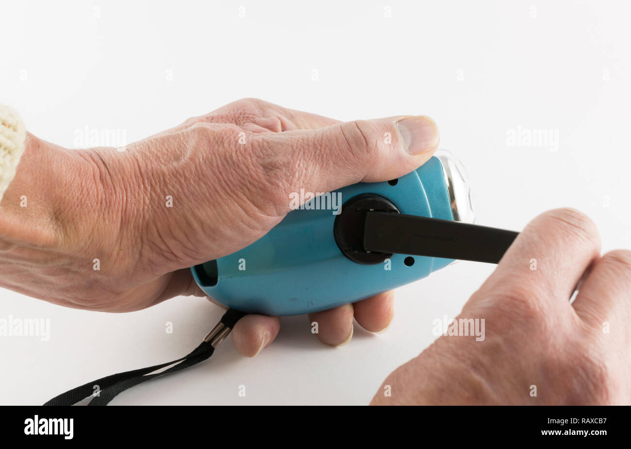 Wind up torch and hands Stock Photo