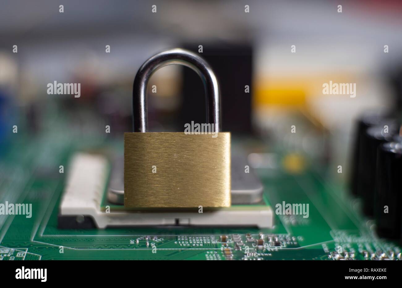 Closed lock on a computer mainboard chip. Digital security, locking