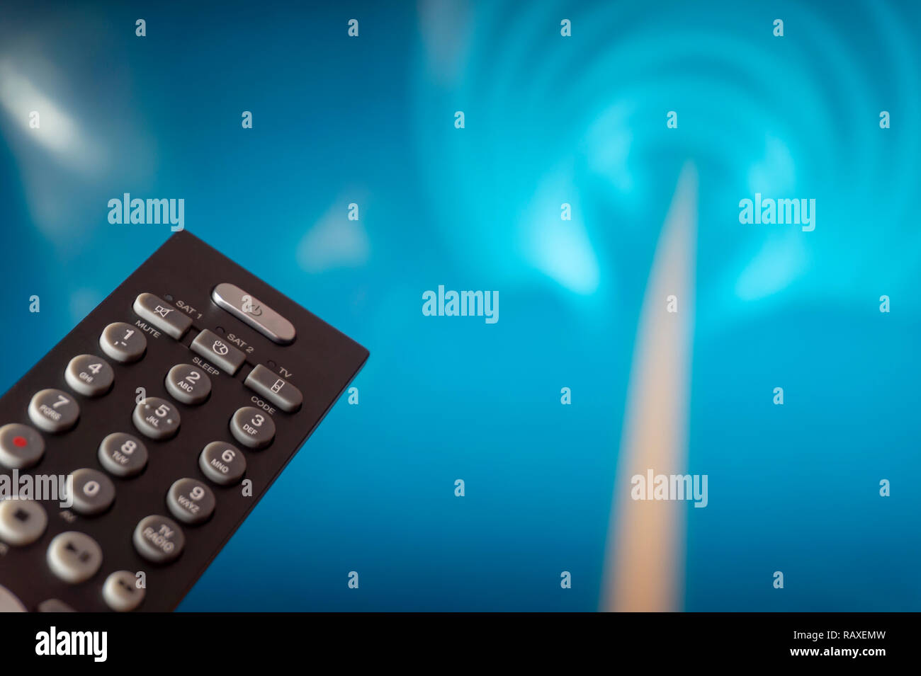 Smart television screen with close up tv remote control in foreground Stock Photo