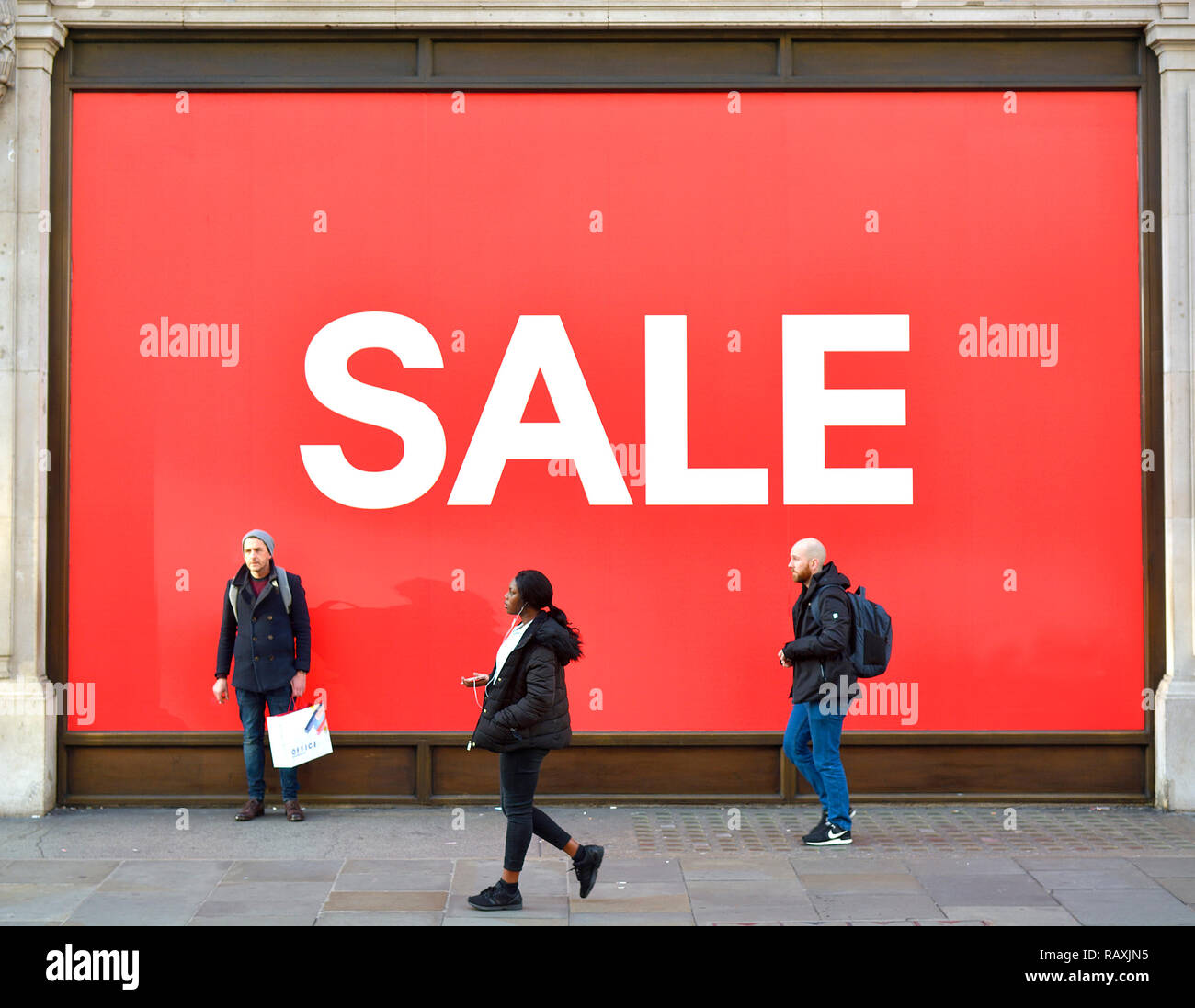 SALE sign in shop window - (H&M, Regent Street) - in January. London, England, UK. [SHOP NAME REMOVED DIGITALLY] Stock Photo
