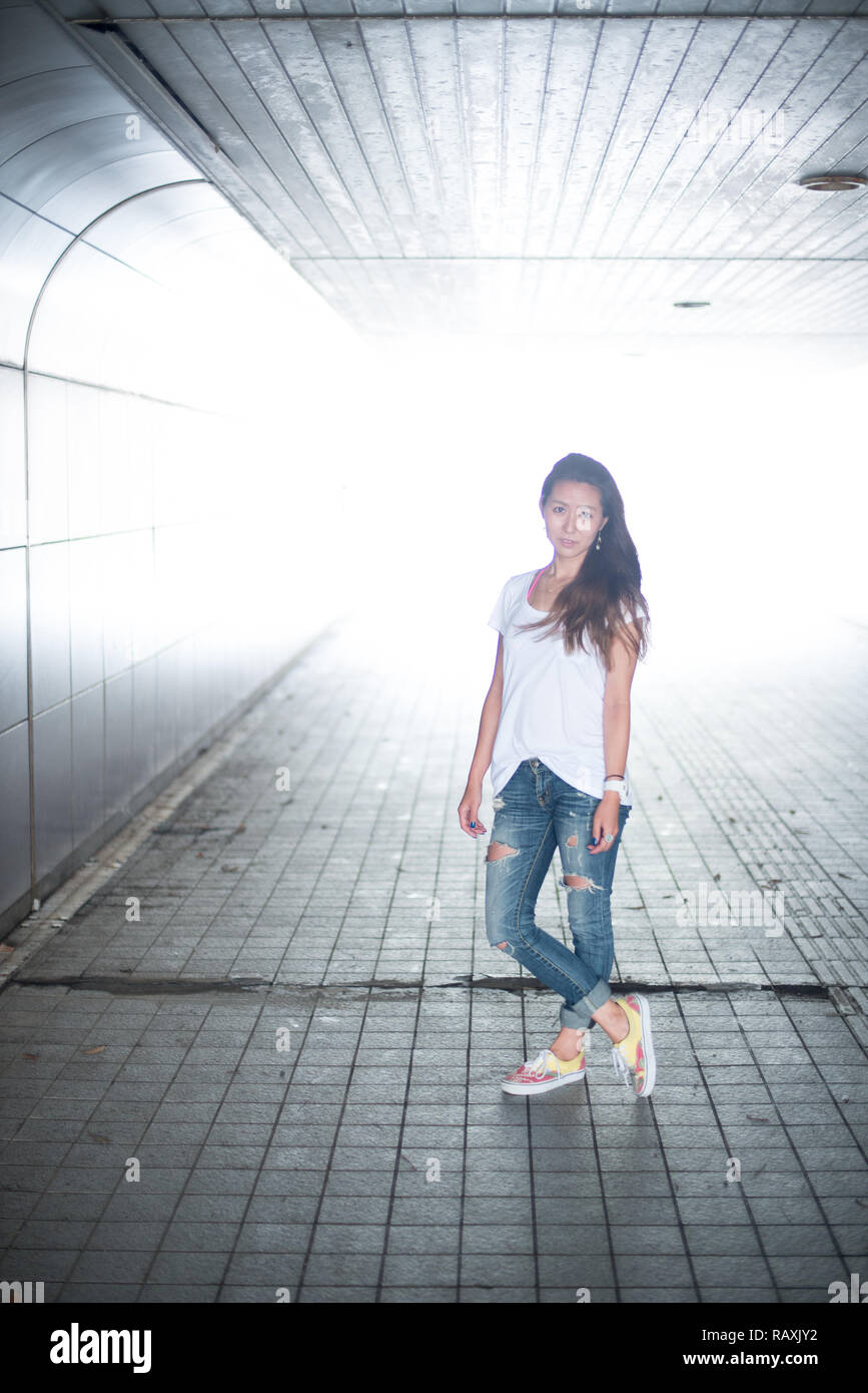 Asian female model poses for pictures on the street Stock Photo
