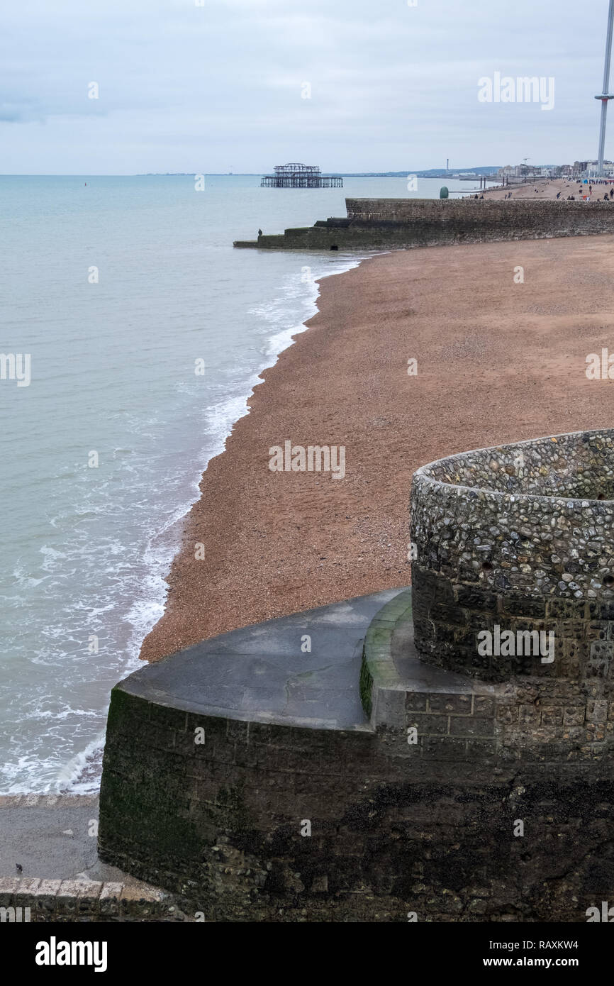 View of Brighton beach with jetty in foreground. Photographed on a cold, cloudy winter's day. Stock Photo
