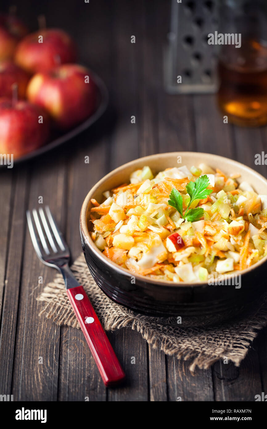 Healthy Raw vegan salad from celery, carrot, cabbage and apples served